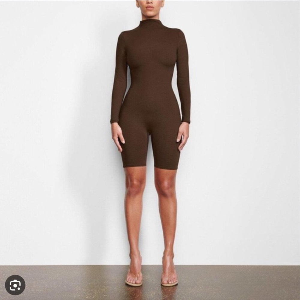 SKIMS All in One Long Sleeve Mid Thigh Onesie in Brown.
